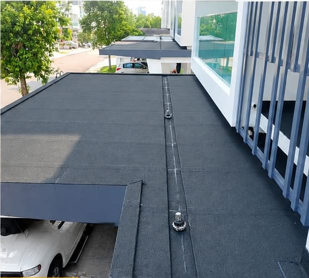 The same car porch slab finished in dark torch-on membrane, a car parked beneath.